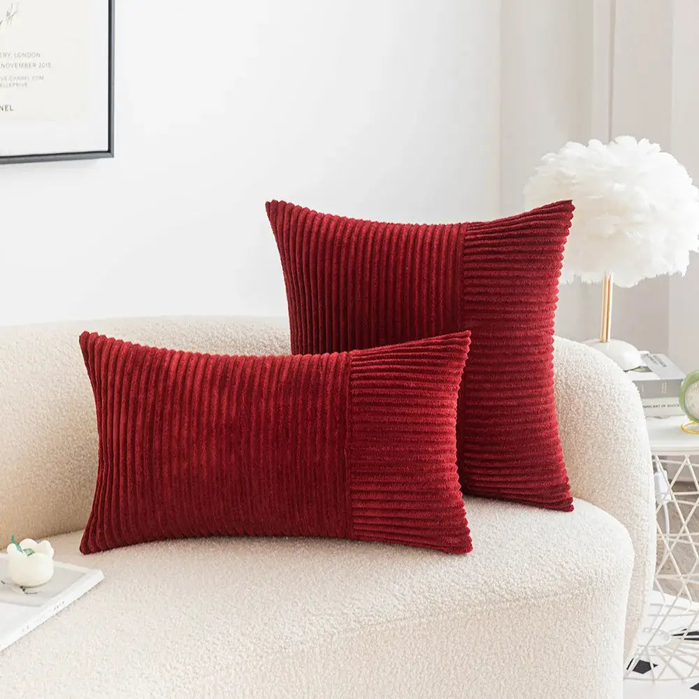 Two rich red decorbites corduroy striped pillow covers in rectangular and square shapes with vertical ribbed texture