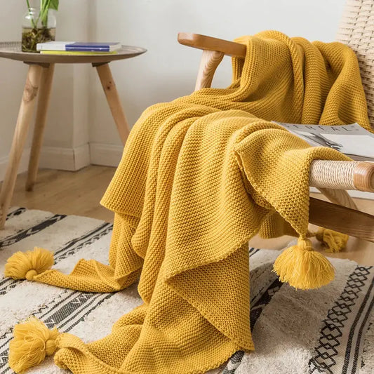 Cozy mustard yellow knit pompom tassel throw blanket with textured stitches and fluffy tassels for bedroom decorbites decor