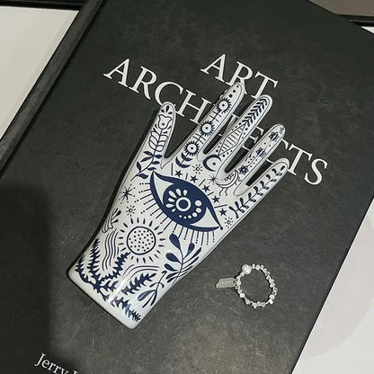 Mystic white and blue ceramic hand jewelry holder stand with intricate patterns and central eye motif for bedroom decor