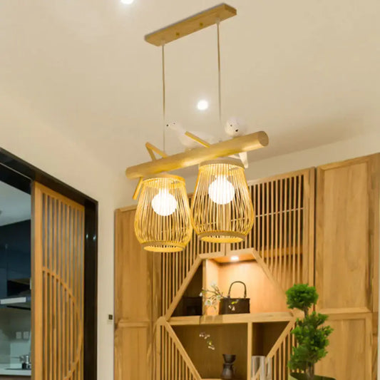 Natural bamboo barrel pendant lights with two woven lanterns and wooden crossbar for dining room island lighting
