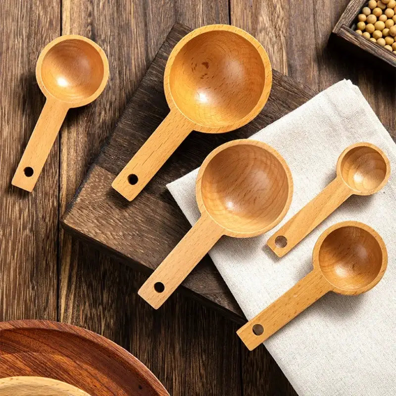 Set of five natural beech wood tablespoon coffee scoops with smooth rounded bowls and small hole handles