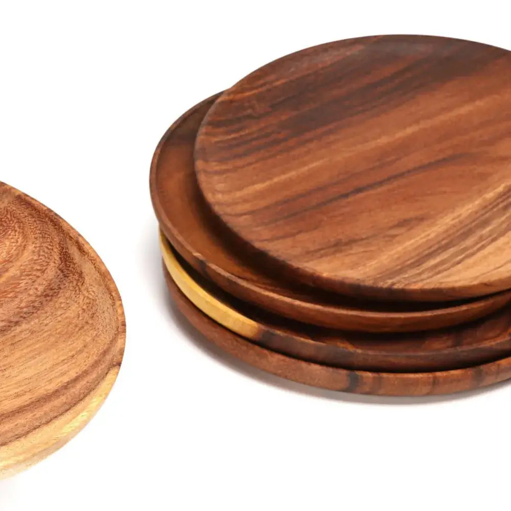 Set of three natural beech wooden round plates with warm brown tones and visible wood grain for kitchen and dining use