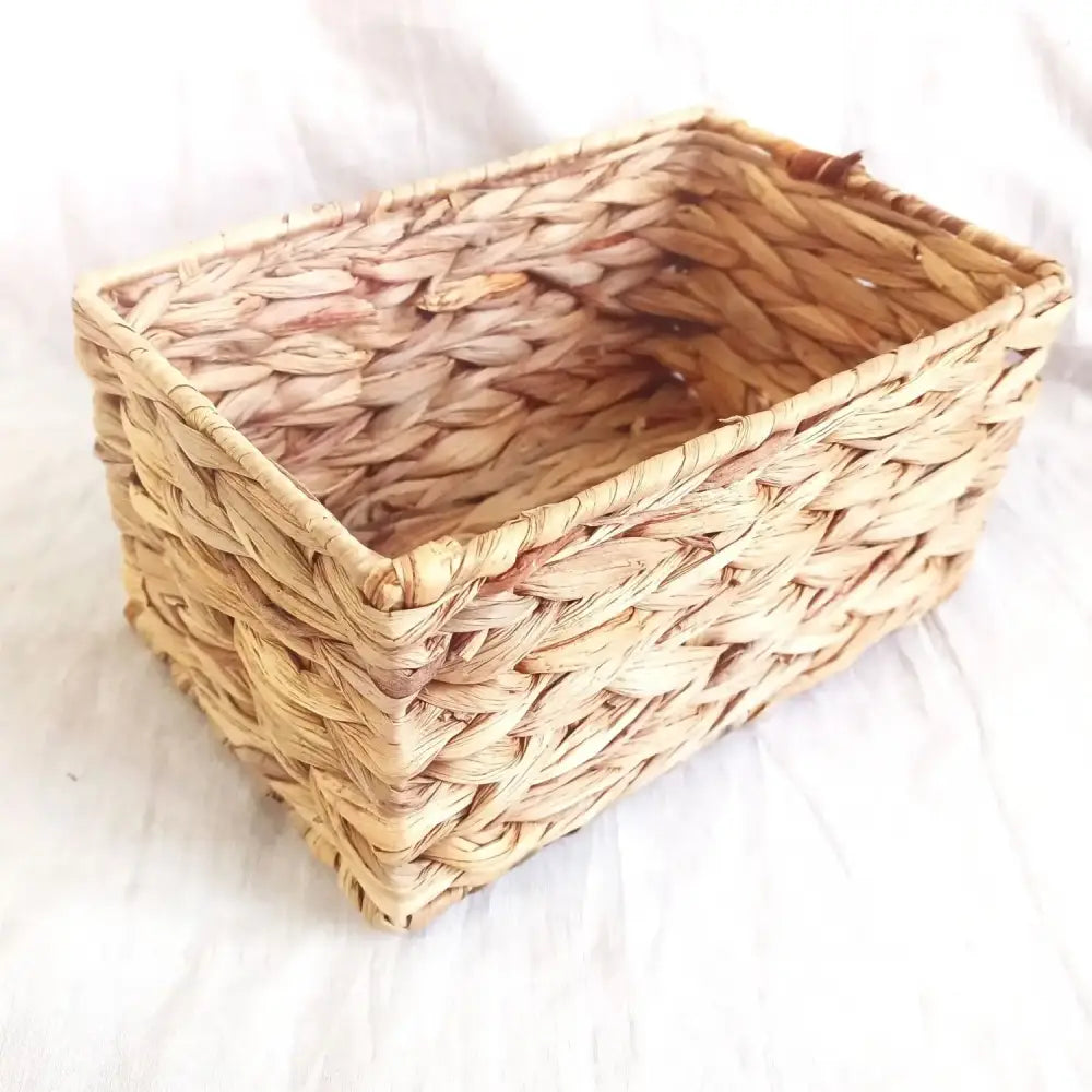 Natural brown and gray woven rattan storage basket made of light tan reeds with a tight interlaced pattern decorbites woven rattan