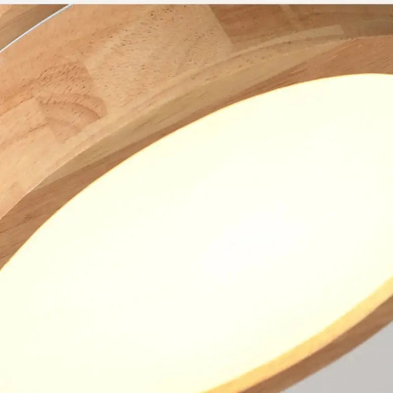 Natural circular wood ceiling lamp with warm-toned wood and smooth oval frosted glass diffuser by decorbites circular wood ceiling