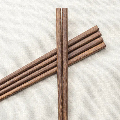 A pair of natural dark brown healthy wood chopsticks with wood grain finish from decorbites wood chopsticks set