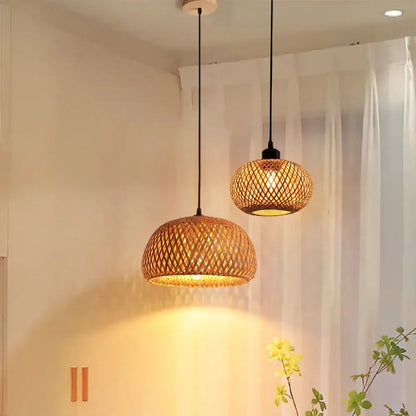 Two warm-toned decorbites bamboo rattan pendant lights with black cords for dining room lighting