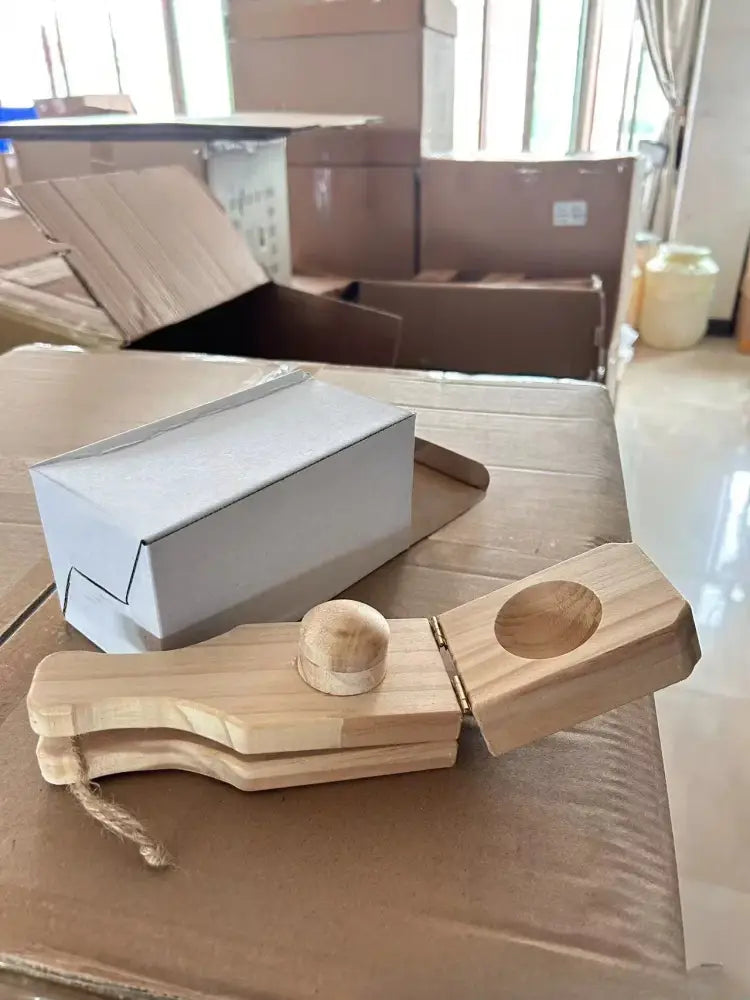 Natural light wood banana smasher and meatball maker kitchen tool with rounded handle and circular hole on wooden banana smasher head
