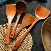 Set of four natural polished wooden kitchen utensils with smooth ergonomic handles kitchen utensil set