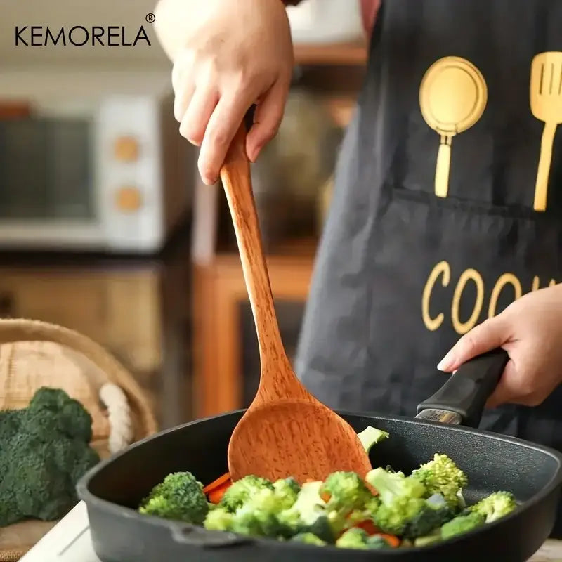 Natural polished wooden kitchen utensil set featuring a smooth light brown wooden kitchen spatula with natural grain