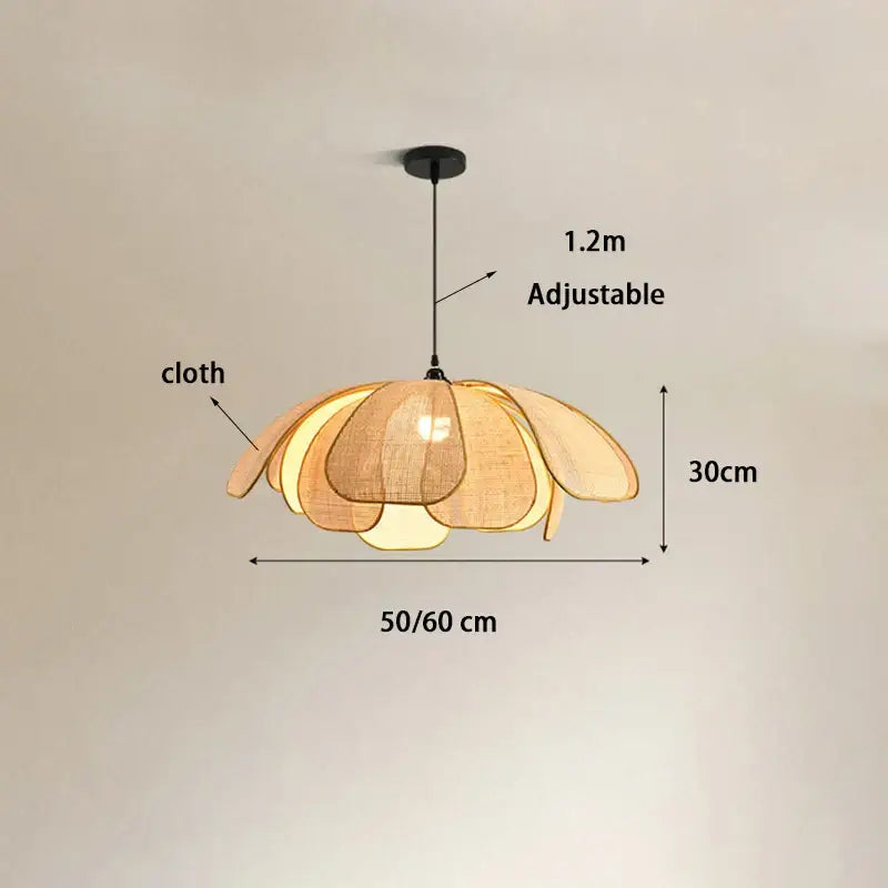 Natural rattan pendant light with warm-toned layered cloth petals and adjustable hanging length for dining room light source