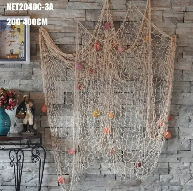Beige decorative fishing net with orange and pink seashells hanging from mesh for nautical bedroom decor
