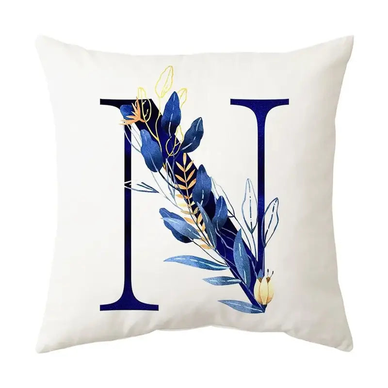 White throw pillow with navy blue alphabet flower letter n featuring decorbites blue alphabet foliage for bedroom decor