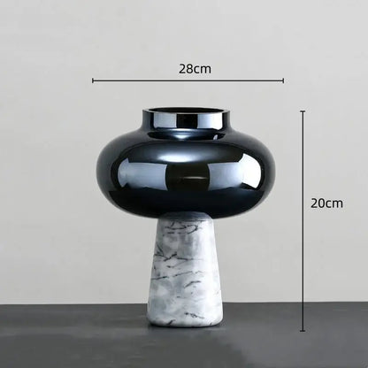 A sleek black glass geometric circle star vase with a marble-patterned base for living room decor