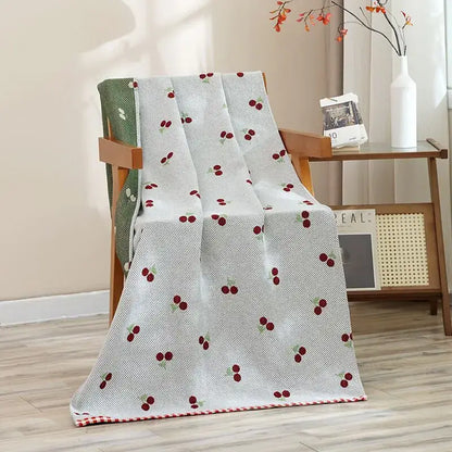 A light gray woven bath towel with embroidered red cherries and checkered border for decorbites cat bath use