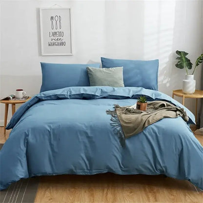 Navy blue solid color decorbites cotton 4pcs bedding set with matching pillows and textured throw blanket on bed