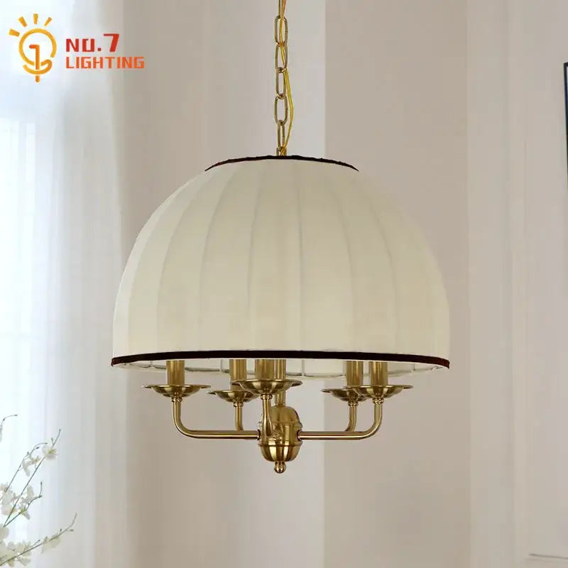 Cream neoclassical pendant light with cream pleated fabric shade black trim brass frame and five candle-style arms