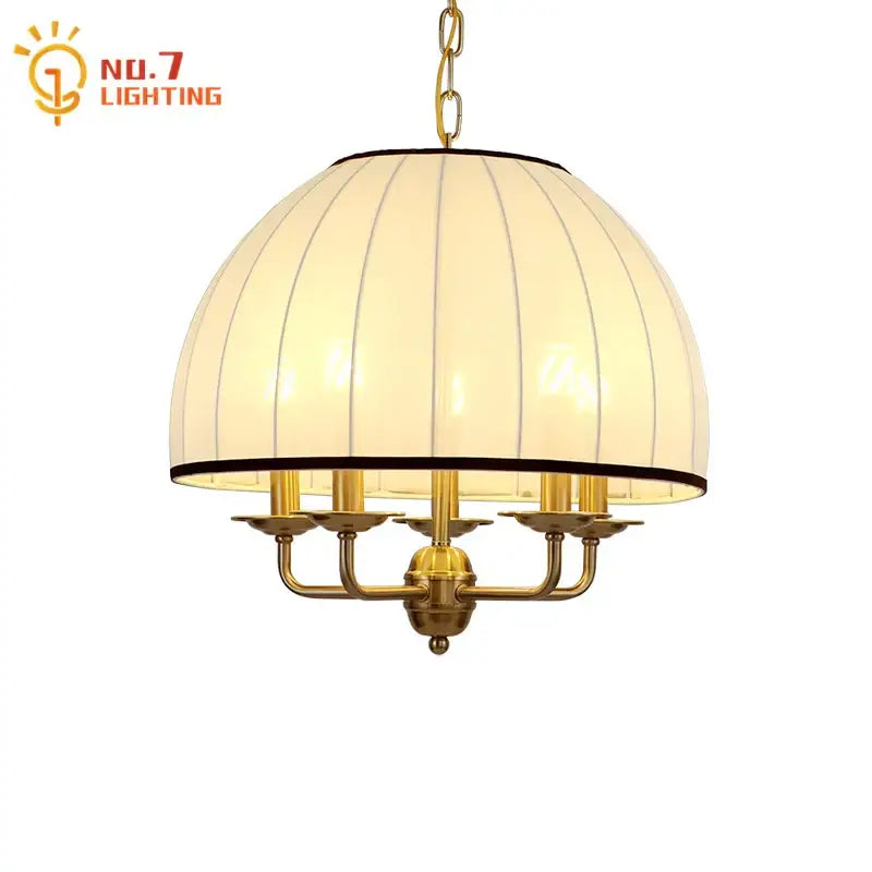 A warm-toned cream neoclassical pendant light with a brass frame and vertical ribbed fabric shade for dining room decorbites