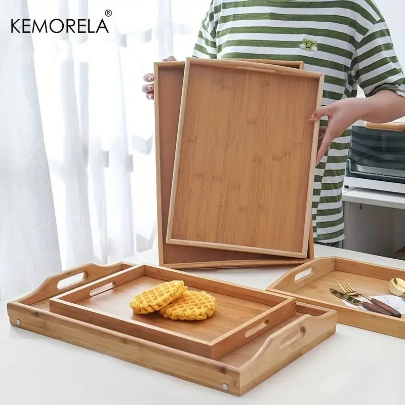 Set of nested light brown rectangular wooden trays made of bamboo with integrated handles for kitchen storage