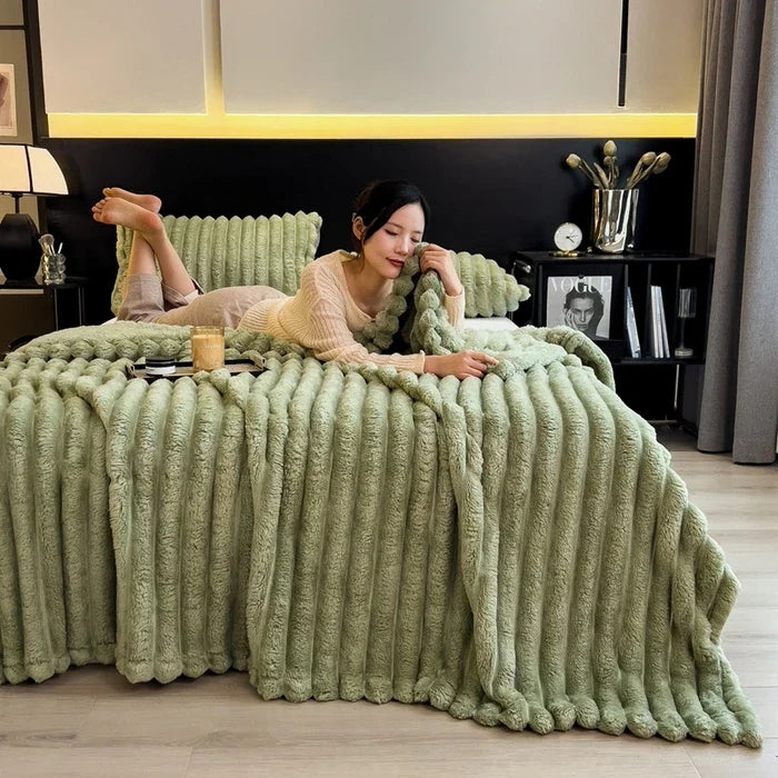 A plush light green chunky knit blanket with ribbed texture made from bamboo fiber ideal for autumn warmth and sofa throws