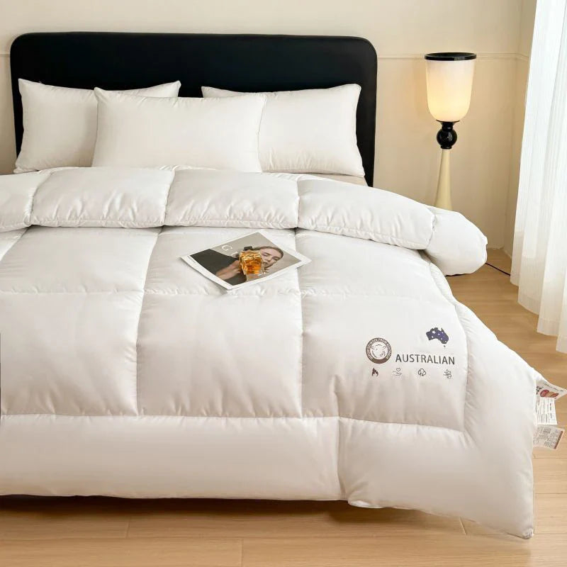 White quilted comforter made of new zealand ultra-fine wool with plush texture and subtle stitching details