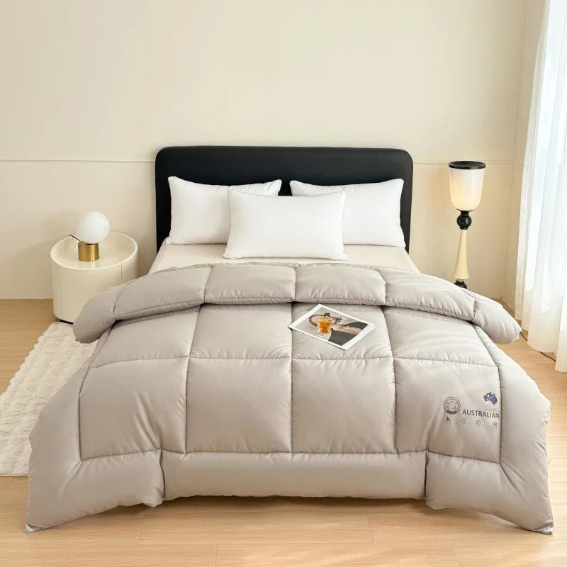 A soft light gray new zealand wool quilt with a subtle australian logo embroidered thick heating blanket