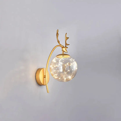 Gold-toned nordic ball wall mount black antler sconce with spherical glass globe and twinkling fairy lights for bedroom