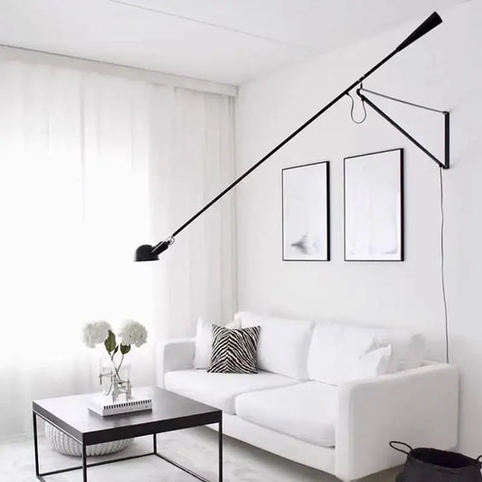 Black articulated wall lamp with adjustable long metal arms and minimalist design for bedroom lighting