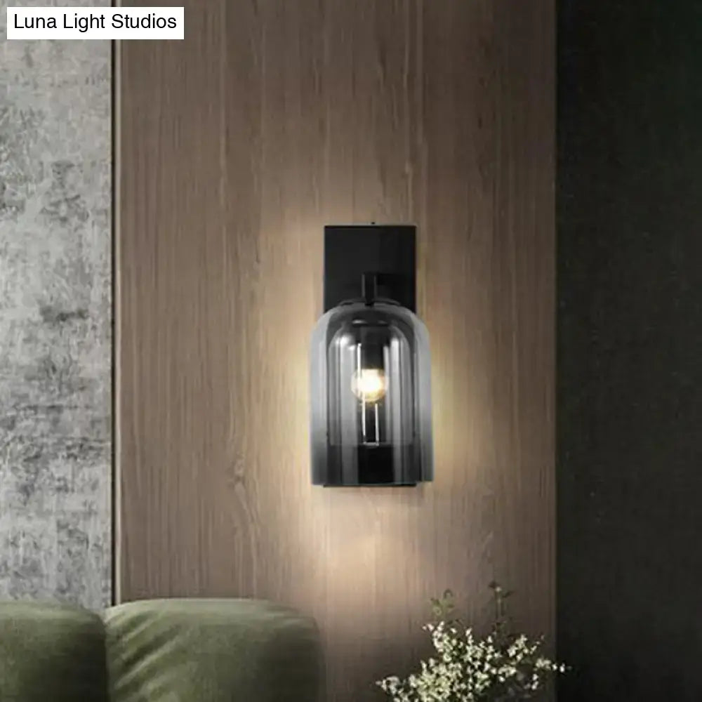 Black metal wall lamp with smoked glass dome shade designed as a nordic bedroom sconce