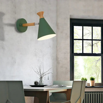 Green conical wall light with metal cone shade and wooden arm suitable for bedroom reading lamp use