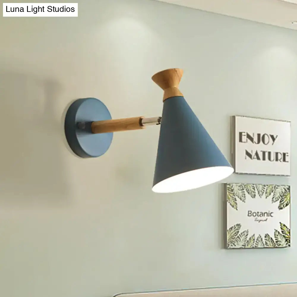 Modern blue wall light featuring a metal cone shade with a wooden arm and base for bedroom reading