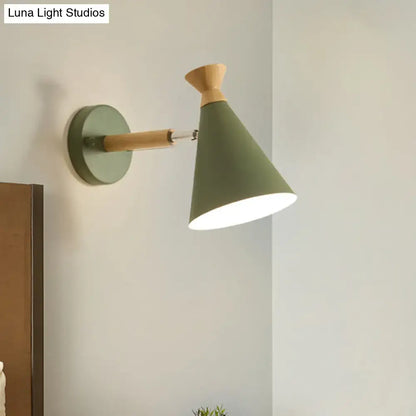 Olive green conical wall light with metal cone shade and natural wood accent featuring an adjustable arm for reading