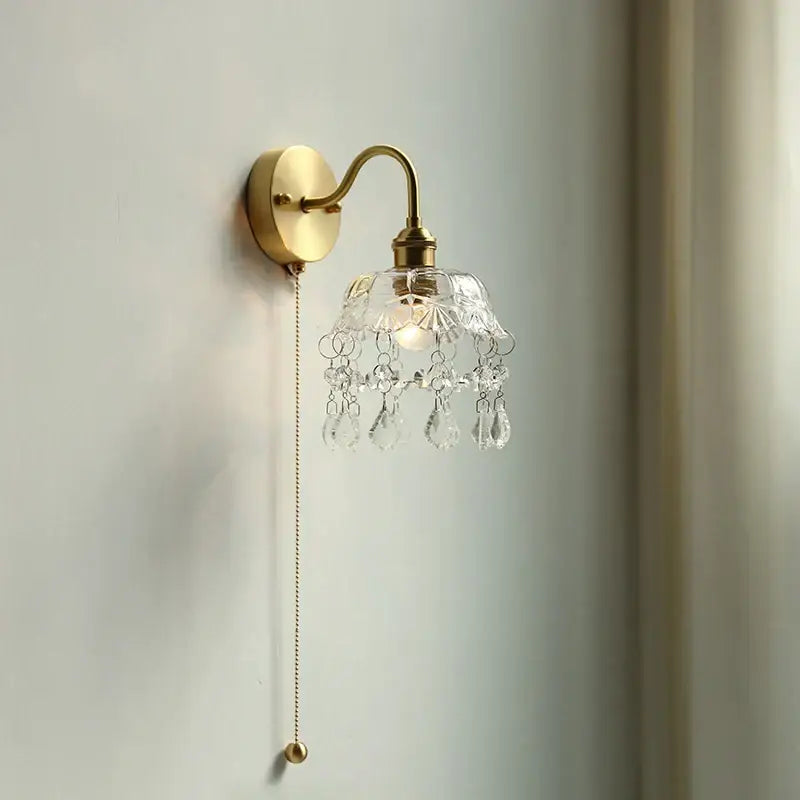 Nordic brass crystal glass led wall light with clear faceted glass shade and dangling crystal teardrops for bedroom decorbites wall light
