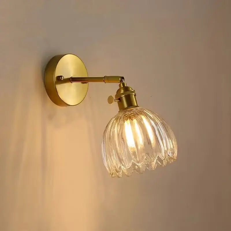 Nordic brass faceted wall light with clear ribbed glass shade for bedroom featuring decorbites clear glass design