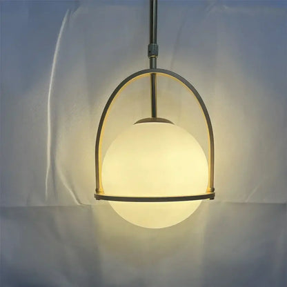 Nordic brass glass globe pendant light with warm frosted glass globe and sleek brass arch frame for kitchen decorbites pendant light