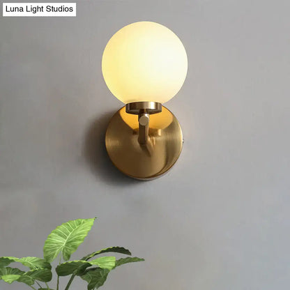 Nordic brass wall sconce light with gold-toned spherical design and frosted glass globe for bedroom lighting 110v-120v 220v-240v