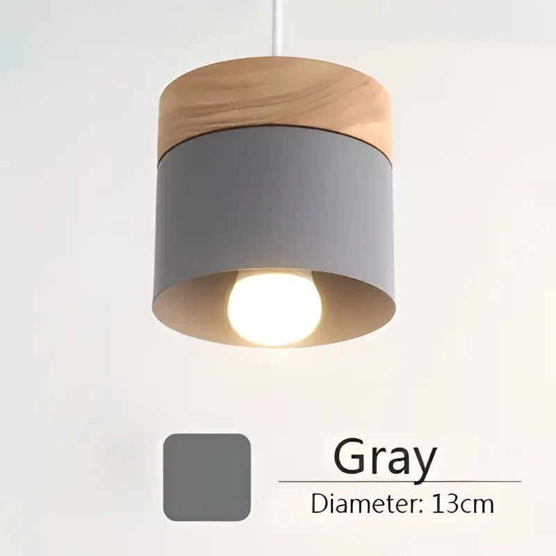 Gray cylindrical pendant light with natural wood top and warm metal accents 13cm diameter from decorbites colorful wood iron collection