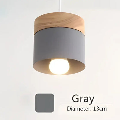 Gray cylindrical pendant light with natural wood top and warm metal accents 13cm diameter from decorbites colorful wood iron collection