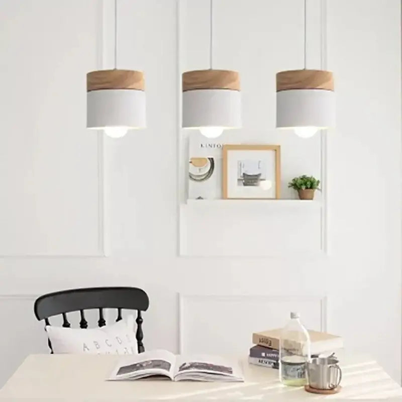 Three cylindrical pendant lights with white matte bodies and natural wood tops for living room decorbites colorful wood iron decor