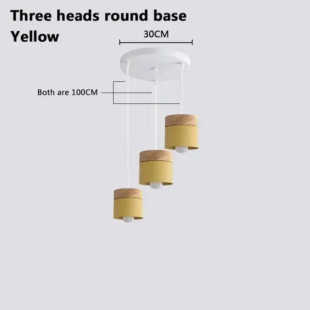 Yellow cylindrical pendant lights with wooden tops suspended from white base for decorbites colorful wood iron decor