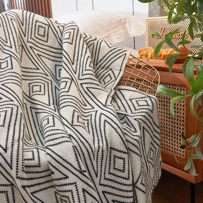 A cream-colored nordic cream and black grey knitted woolen blanket with bold geometric pattern for living room decorbites grey knitted throw