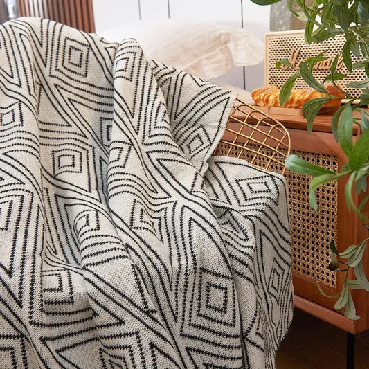 A cream-colored nordic cream and black grey knitted woolen blanket with bold geometric pattern for living room decorbites grey knitted throw