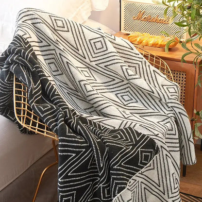 Black and white geometric grey knitted woolen blanket draped over gold wire chair for living room decorbites grey knitted throw