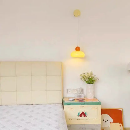 A cheerful yellow and orange dome-shaped pendant lamp hanging from a slender cord decorbites iron nordic wall light fixture