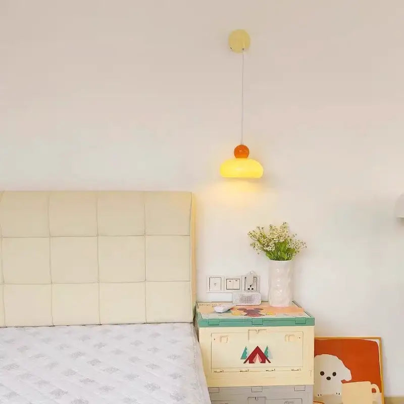 A cheerful yellow and orange dome-shaped pendant lamp hanging from a slender cord decorbites iron nordic wall light fixture