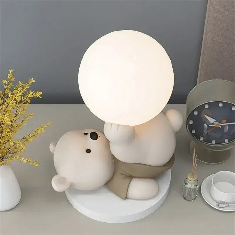 Nordic cream ceramic bear table lamp with an off-white polar bear holding a frosted glass globe bear table lamp