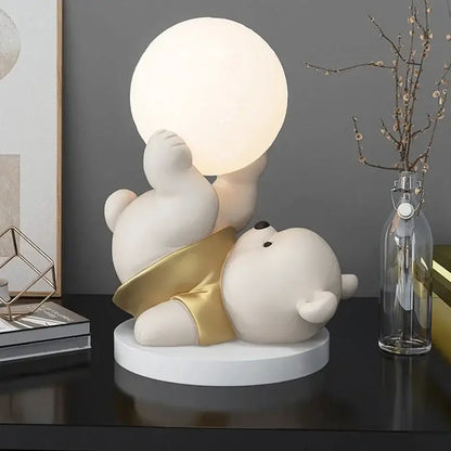 Nordic cream ceramic bear table lamp featuring a cute white polar bear with gold shorts holding a glowing light sphere