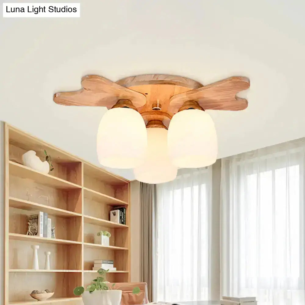Nordic cream glass bell ceiling light with wood antler and three frosted cream glass shades in warm natural wood finish