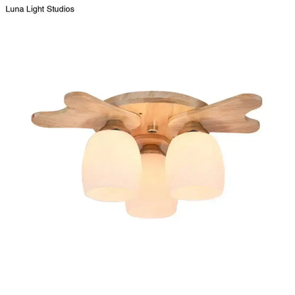 Nordic cream glass bell ceiling light with light wood finish and three frosted cream glass shades for bedroom