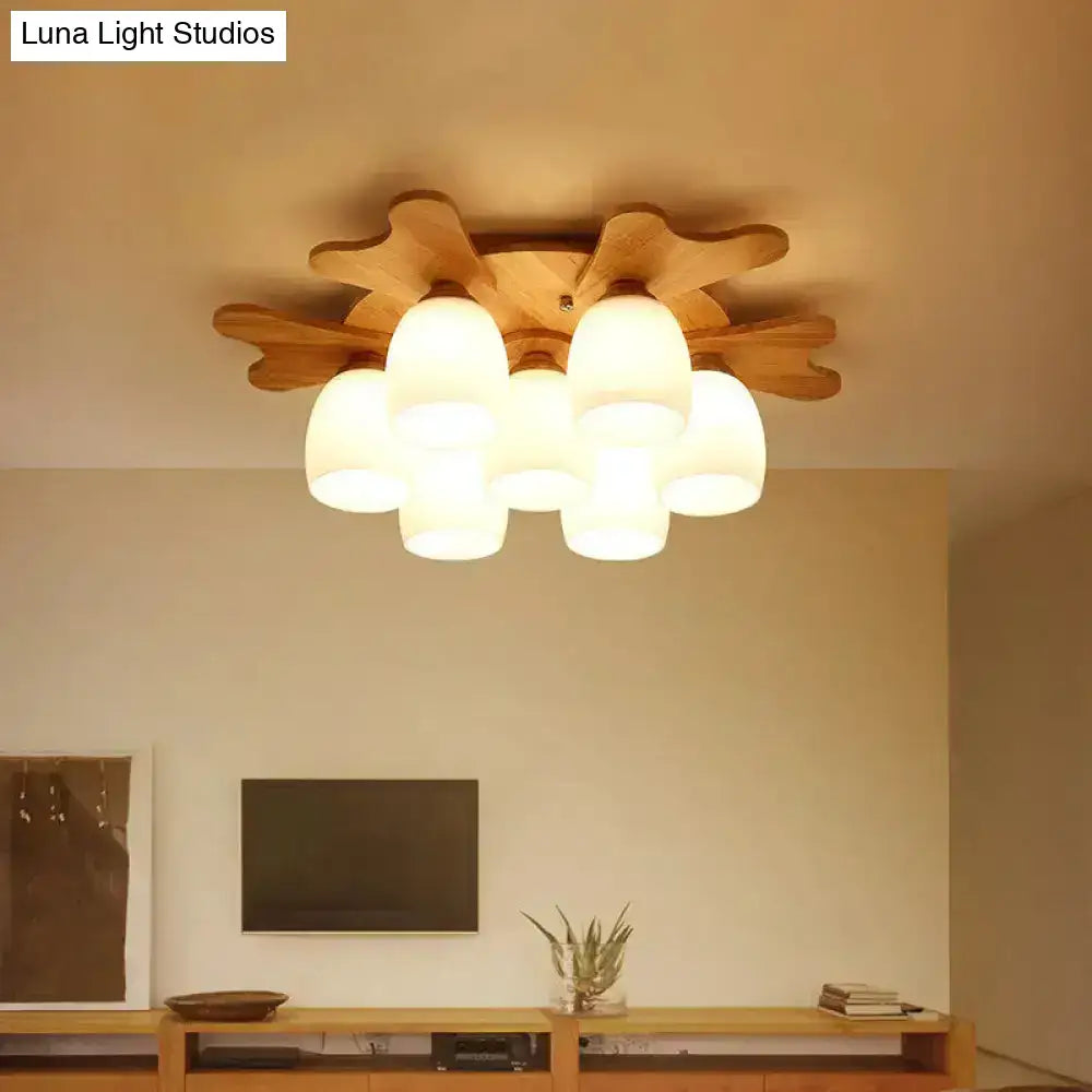 Nordic cream glass bell ceiling light with warm-toned wood antler and leaf design featuring six frosted glass shades