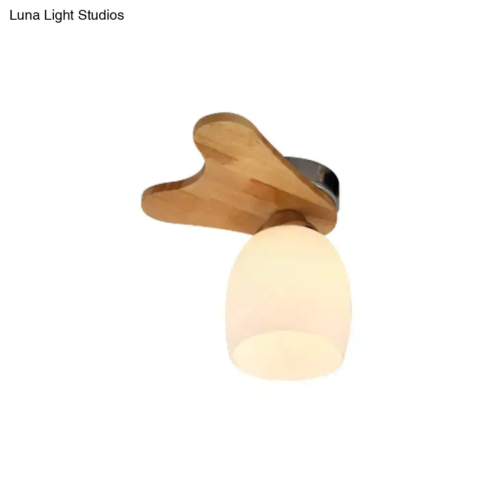 Nordic cream glass bell ceiling light with wood antler and warm-toned leaf-shaped shade for bedroom lighting